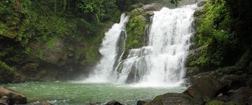 Water spills over the 60-foot Nauyaca falls outside Dominical on August 9, 2013. Horseback tours to the waterfalls include breakfast, lunch and cliff diving off the falls.