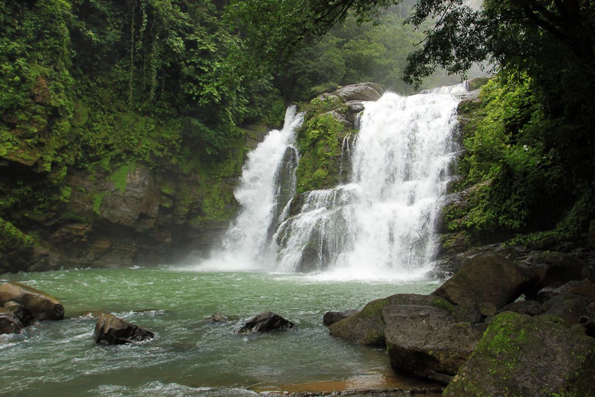 Water spills over the 60-foot Nauyaca falls outside Dominical on August 9, 2013. Horseback tours to the waterfalls include breakfast, lunch and cliff diving off the falls.