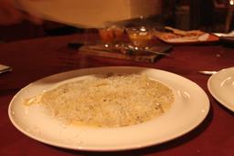 grating cheese on black truffle cream ravioli 3