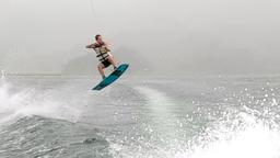 a man up in the air wakeboarding on lake arenal