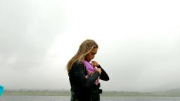 a lady secures her gear to start wakeboarding
