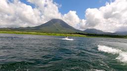 a man starting to wakeboard on lake arenal