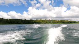 a make jumping above lake arenal as he wakeboards