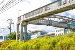 pedestrian bridge in front of the lots in escazu