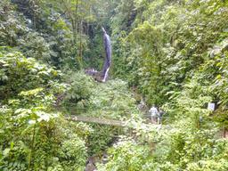 blue morpho waterfall with people arenal hanging bridges mistico park