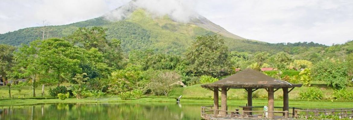 volcano view from entrance lake kiosk at los lagos hotel resort and spa