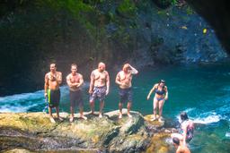portalon waterfall people standing on rocks waterfall tour manuel antonio