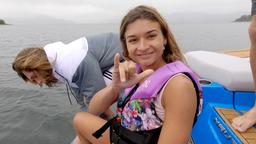 lady smiles to the camera as she prepares for jumping in the lake