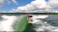 a woman wakesurfing on a sunny day on lake arenal
 - Costa Rica