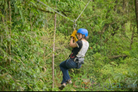 Woman Riding A Zip Line Cable Blue River Zipline Rincon De La Vieja
 - Costa Rica