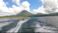 a couple of friends tubing on lake arenal with the view of the volcano
 - Costa Rica