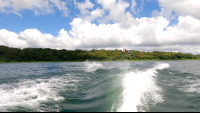 a make jumping above lake arenal as he wakeboards
 - Costa Rica