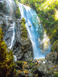        Man Rappelling Down Ventana De Cielo Waterfall
  - Costa Rica