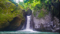        Man Standing On Balanced Rock Of Pavon Waterfall Tour Manuel Antonio
  - Costa Rica