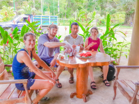 People Enjoying Fresh Fruit After Corcovado Canopy Tour
 - Costa Rica