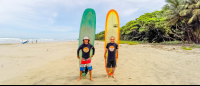 Olingo Tours Surf Lesson Students Holding Board
 - Costa Rica
