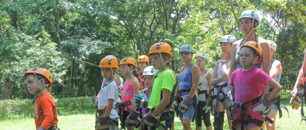 children listening to instructions to do canopy tour
 - Costa Rica