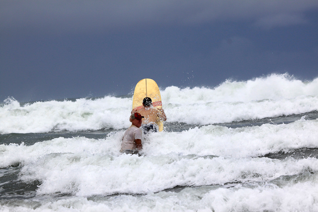        lagarto surf company in the waves 
  - Costa Rica