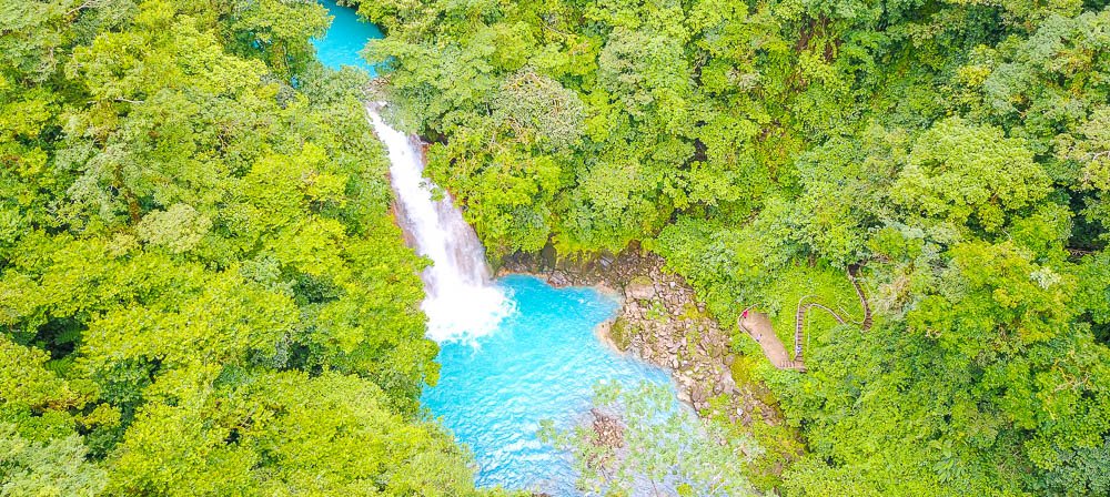 celeste river waterfall aerial view with step trail dji
 - Costa Rica