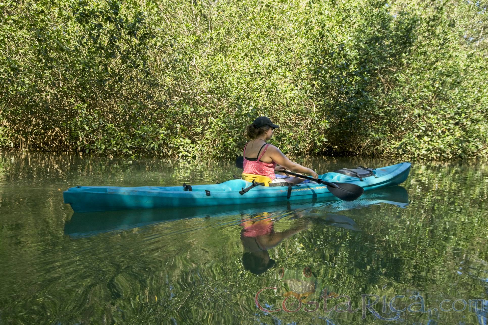 nosara joe kayak lady on a boat floating in mangrove
 - Costa Rica